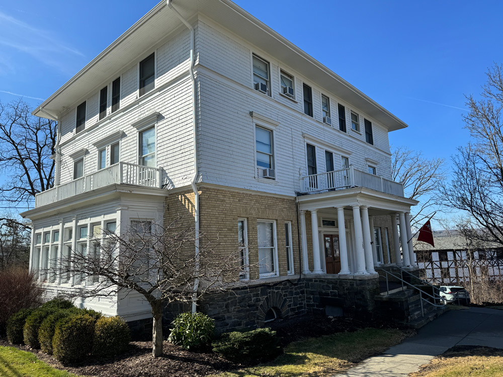 Large white house which is home to the Veterans House program house community